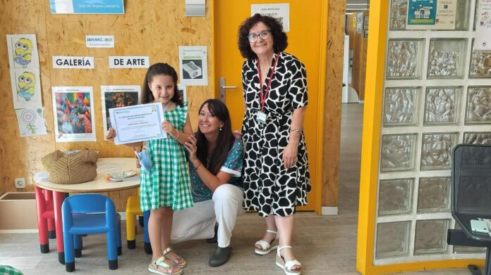 La pequeña ganadora posa con su certificado del primer premio