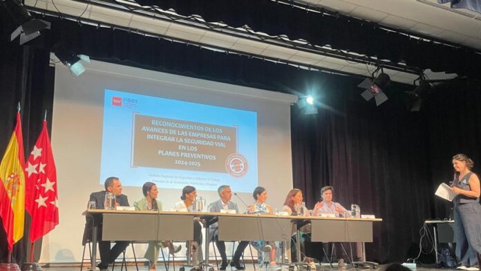 escenario con mesa y ponentes entrega reconocimientos seguridad vial laboral
